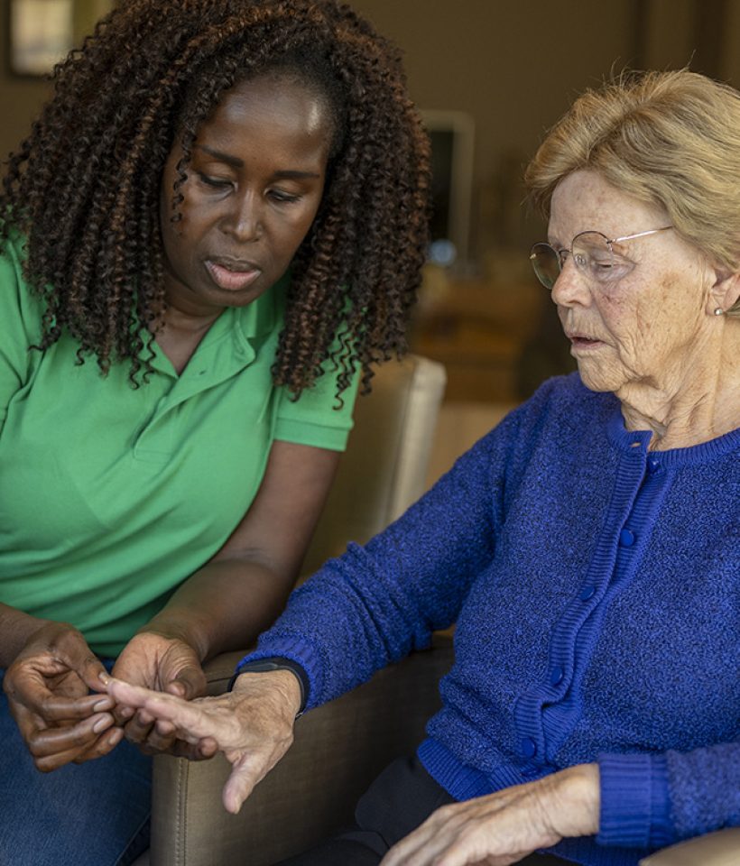 Helper caring for elderly lady